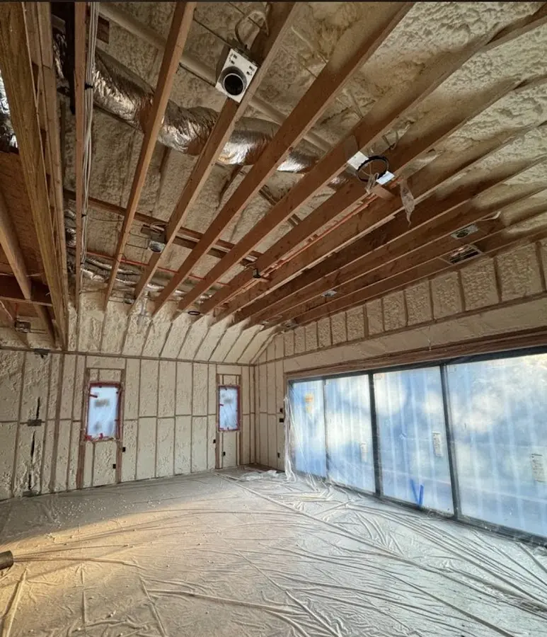 Interior walls and ceiling insulated with spray foam during new construction in Burlingame